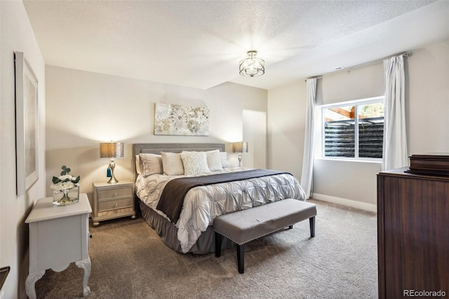 carpeted bedroom with baseboards and a textured ceiling