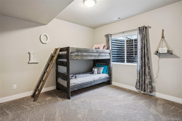 carpeted bedroom featuring baseboards
