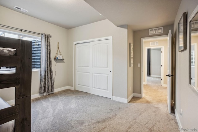 unfurnished bedroom with carpet floors, a closet, and baseboards