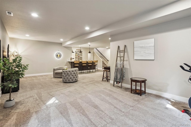 living area featuring carpet floors, recessed lighting, a bar, stairs, and baseboards