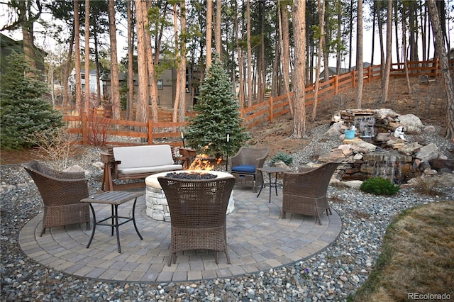 view of patio / terrace featuring a fire pit and a fenced backyard