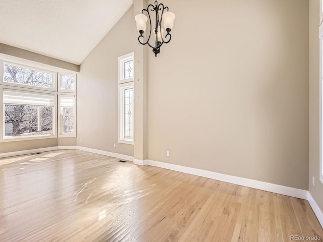 unfurnished dining area featuring light wood-type flooring, visible vents, a notable chandelier, and baseboards