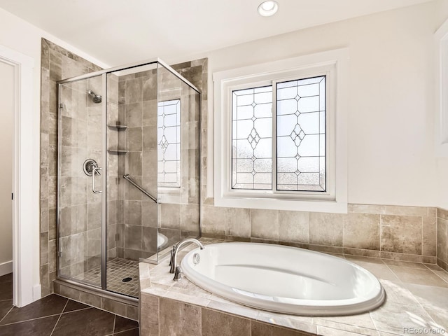 bathroom with a garden tub, a shower stall, and tile patterned floors