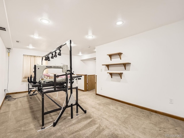 exercise room with light carpet, visible vents, and baseboards