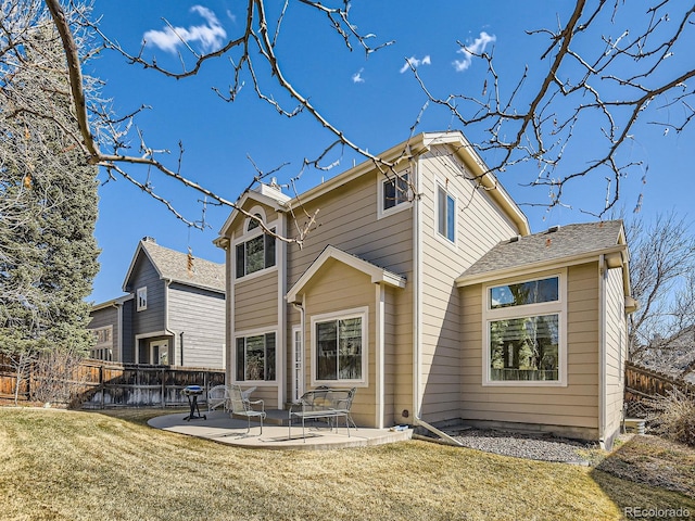 back of house with fence, a lawn, and a patio