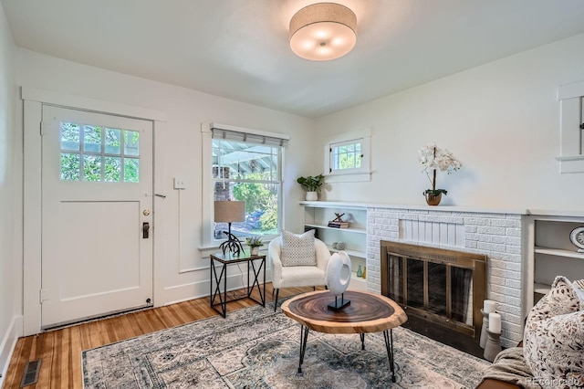 sitting room with wood finished floors and a fireplace