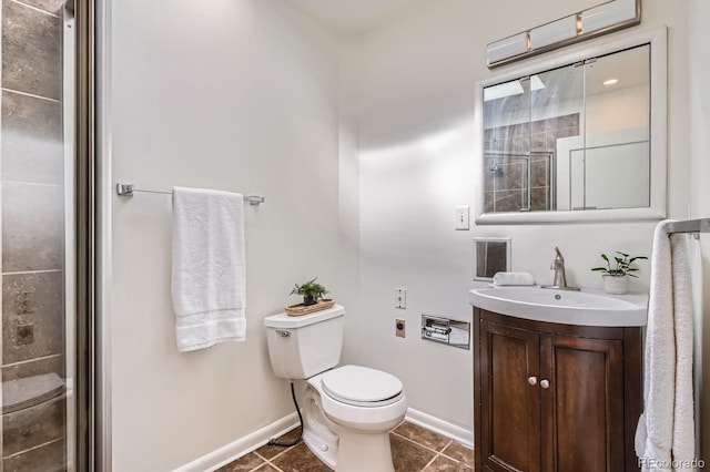 bathroom with toilet, tile patterned flooring, vanity, baseboards, and a shower