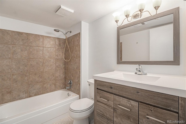 full bathroom featuring vanity, tiled shower / bath combo, and toilet