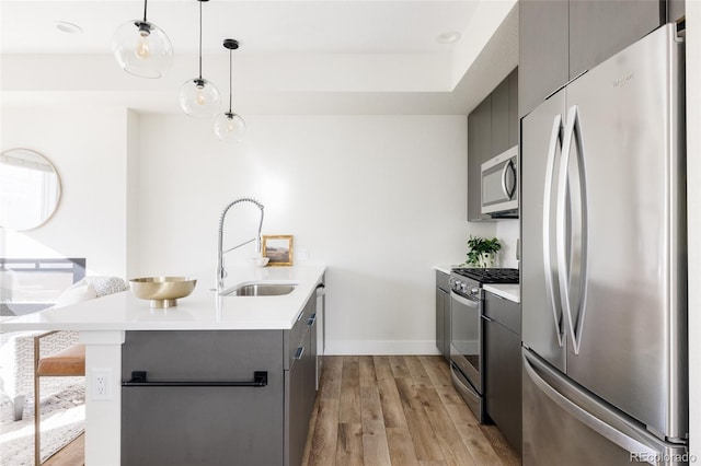 kitchen with stainless steel appliances, modern cabinets, a peninsula, and gray cabinetry