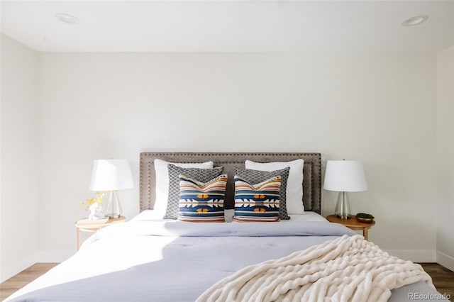 bedroom featuring recessed lighting, wood finished floors, and baseboards