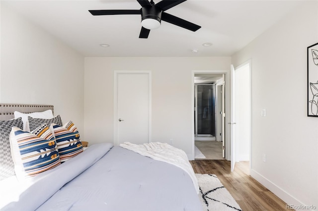 bedroom featuring ceiling fan, baseboards, and wood finished floors