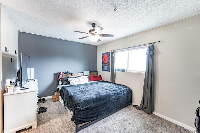 bedroom with carpet flooring, baseboards, a textured ceiling, and ceiling fan