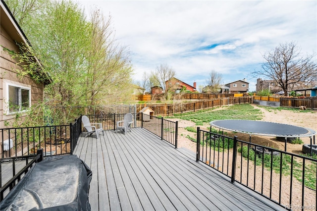 wooden terrace with a fenced backyard and a residential view