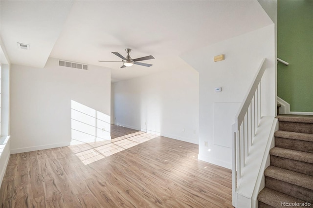 unfurnished living room featuring light hardwood / wood-style flooring and ceiling fan