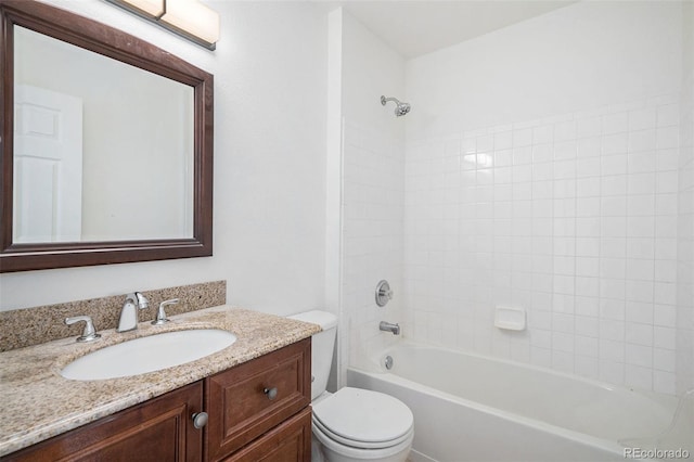 full bathroom with vanity, tiled shower / bath combo, and toilet