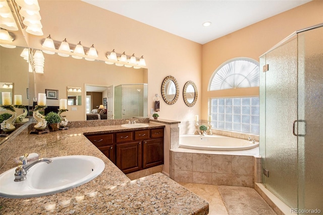 bathroom with tile patterned flooring, vanity, and separate shower and tub