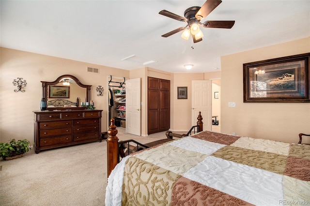 bedroom featuring ceiling fan, light colored carpet, and a closet