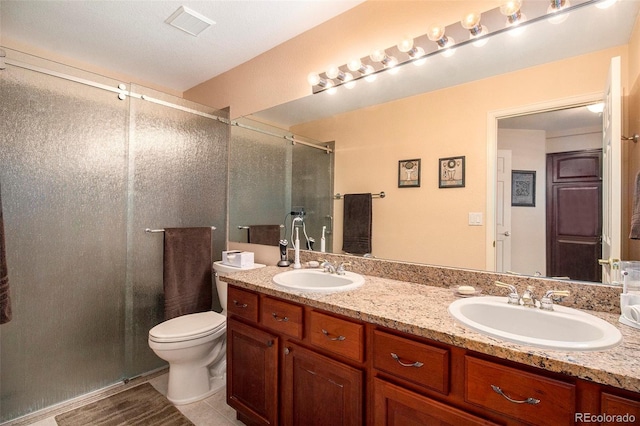 bathroom with vanity, toilet, and an enclosed shower