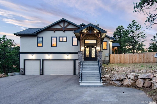 24701 US Highway 40, Golden, CO 80401 - view of front of house featuring stone siding, stucco siding, an attached garage, and fence