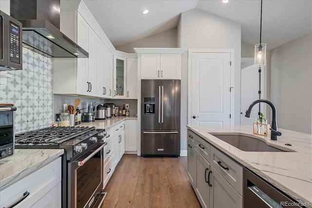24701 US Highway 40, Golden, CO 80401 - kitchen with premium appliances, a sink, wall chimney range hood, glass insert cabinets, and dark wood-type flooring