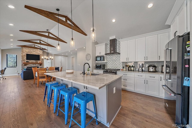 24701 US Highway 40, Golden, CO 80401 - kitchen featuring high end appliances, wall chimney range hood, a sink, dark wood-type flooring, and high vaulted ceiling