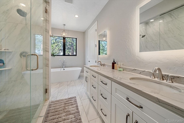 24701 US Highway 40, Golden, CO 80401 - bathroom featuring a shower stall, a freestanding bath, a textured wall, double vanity, and recessed lighting