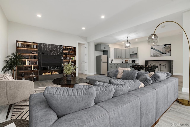 24701 US Highway 40, Golden, CO 80401 - living area featuring light wood-type flooring, baseboards, recessed lighting, and a large fireplace