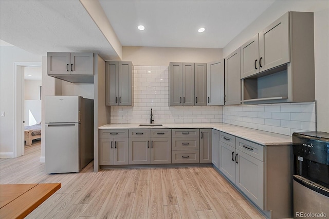 24701 US Highway 40, Golden, CO 80401 - kitchen featuring freestanding refrigerator, gray cabinets, a sink, light wood-type flooring, and recessed lighting