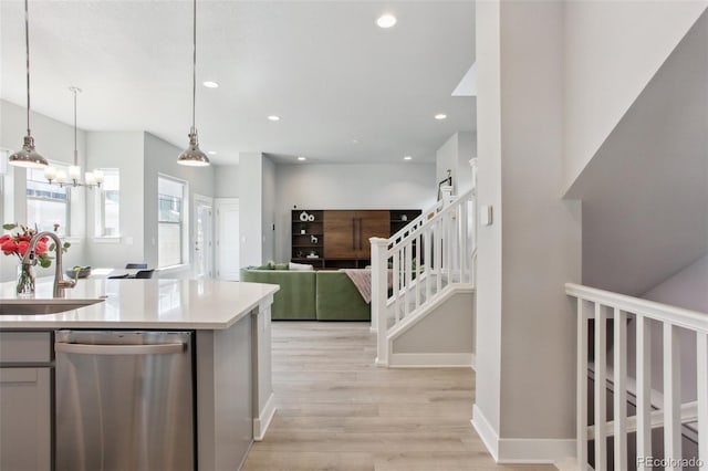 kitchen with a sink, light wood-type flooring, dishwasher, and recessed lighting