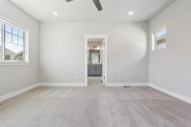 unfurnished bedroom featuring light carpet, baseboards, connected bathroom, ceiling fan, and recessed lighting