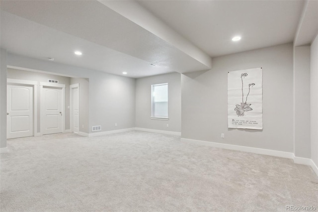 empty room featuring visible vents, recessed lighting, light colored carpet, and baseboards