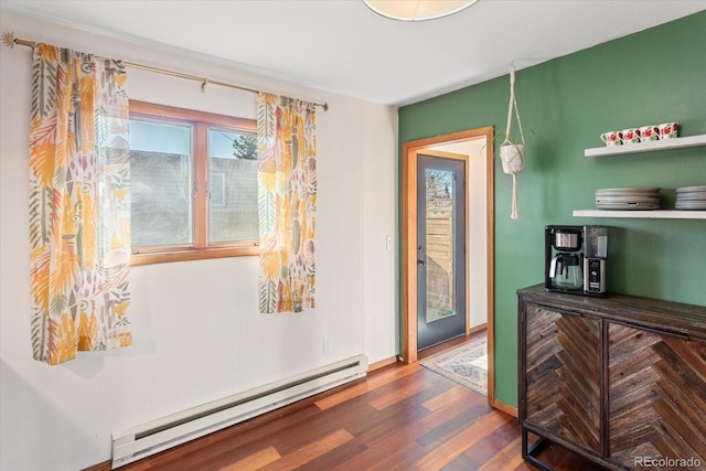 interior space with a baseboard radiator and dark wood-type flooring