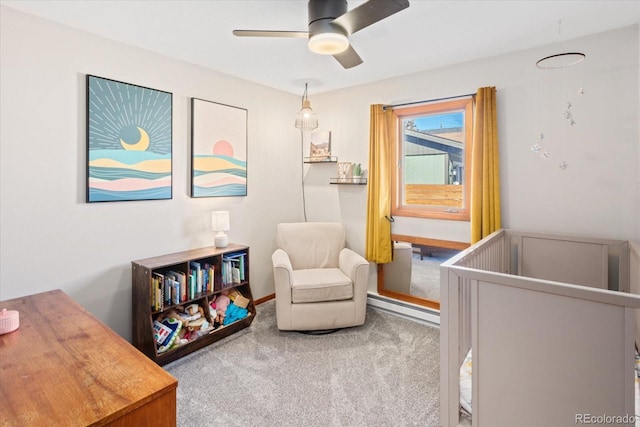 bedroom with a nursery area, ceiling fan, and carpet floors