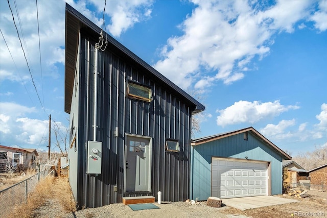 view of front facade with an outbuilding and a garage