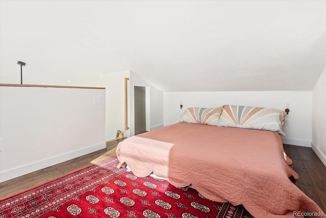 bedroom featuring lofted ceiling and dark hardwood / wood-style floors