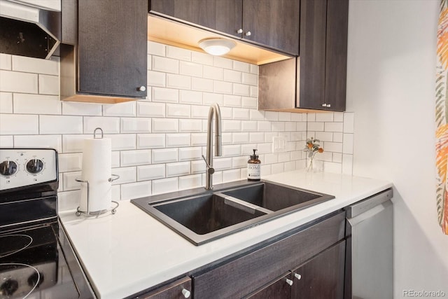 kitchen with dark brown cabinetry, stainless steel appliances, sink, and decorative backsplash