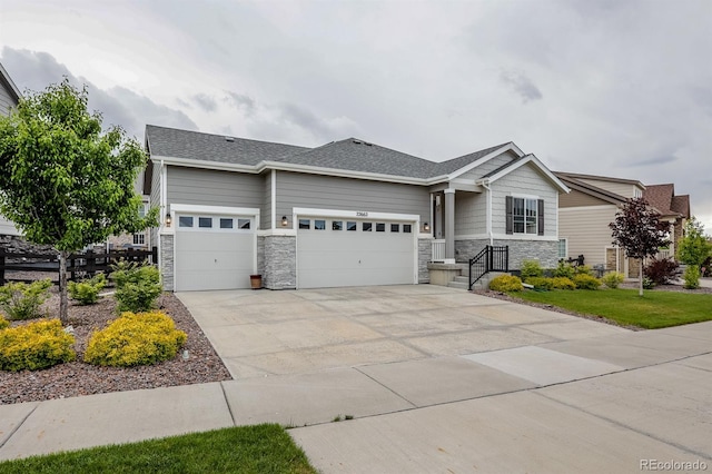 22662 E Narrowleaf Cir, Aurora, CO 80016 - view of front facade featuring a garage, stone siding, and driveway