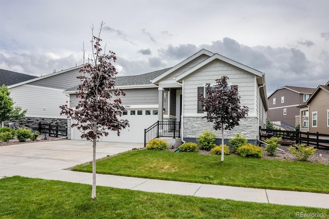 22662 E Narrowleaf Cir, Aurora, CO 80016 - ranch-style home featuring concrete driveway, a garage, and stone siding
