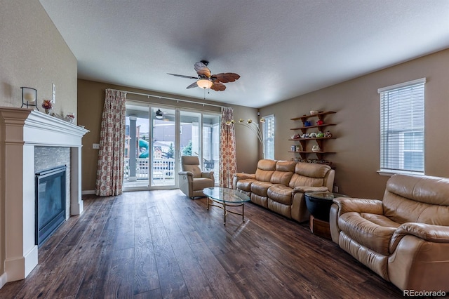 22662 E Narrowleaf Cir, Aurora, CO 80016 - living room with a ceiling fan, dark wood finished floors, a fireplace, baseboards, and a textured ceiling