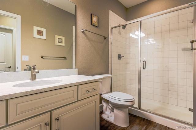 22662 E Narrowleaf Cir, Aurora, CO 80016 - full bath featuring wood finished floors, toilet, vanity, a stall shower, and a textured wall