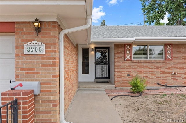 8205 Pennsylvania St, Denver, CO 80229 - entrance to property with brick siding and roof with shingles