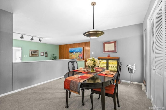 8205 Pennsylvania St, Denver, CO 80229 - carpeted dining room with wooden walls and track lighting