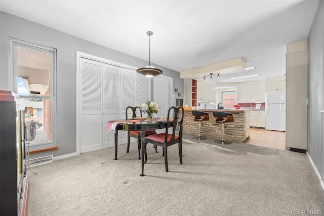8205 Pennsylvania St, Denver, CO 80229 - dining space with light colored carpet and baseboards