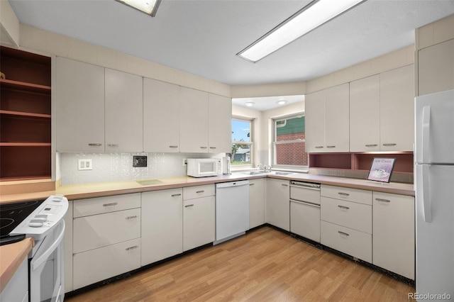 8205 Pennsylvania St, Denver, CO 80229 - kitchen featuring white appliances, light wood finished floors, white cabinetry, light countertops, and open shelves