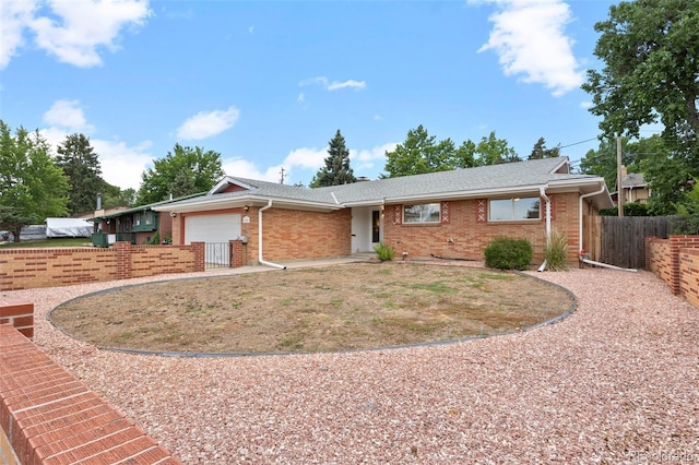 8205 Pennsylvania St, Denver, CO 80229 - ranch-style house with a garage, brick siding, and roof with shingles