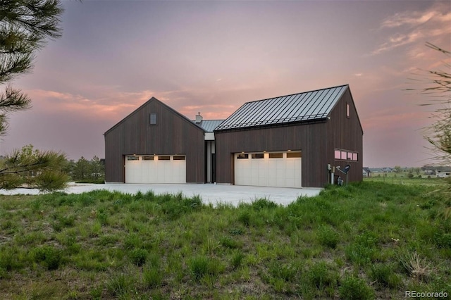 view of garage at dusk