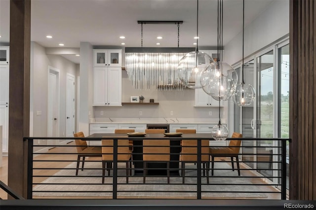 kitchen featuring white cabinets, pendant lighting, and an inviting chandelier