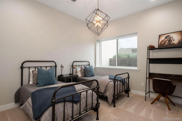 carpeted bedroom featuring baseboards and an inviting chandelier