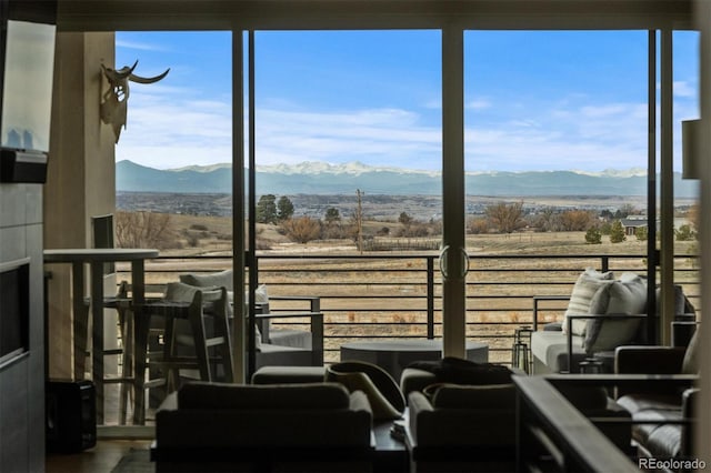 living area with a mountain view and a rural view