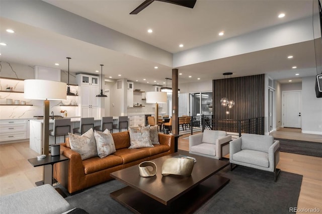 living area featuring recessed lighting, light wood-style floors, and ceiling fan